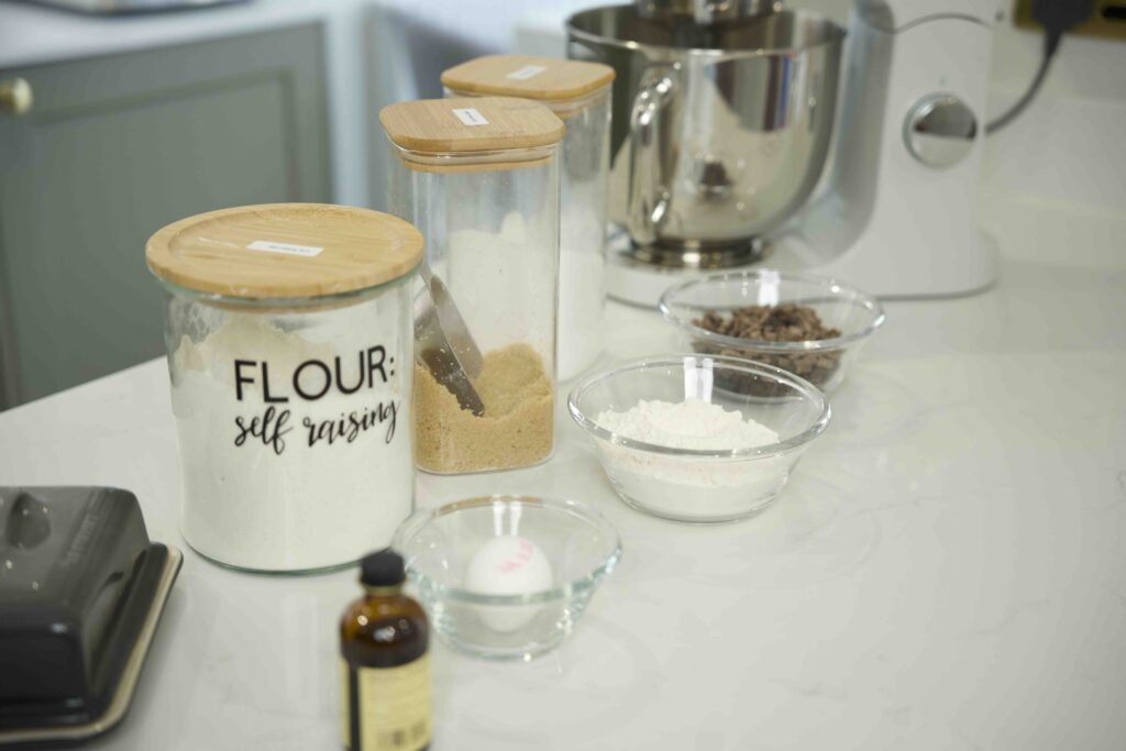 KITCHEN STORAGE JARS AND A MIXER ON A COUNTER TOP 